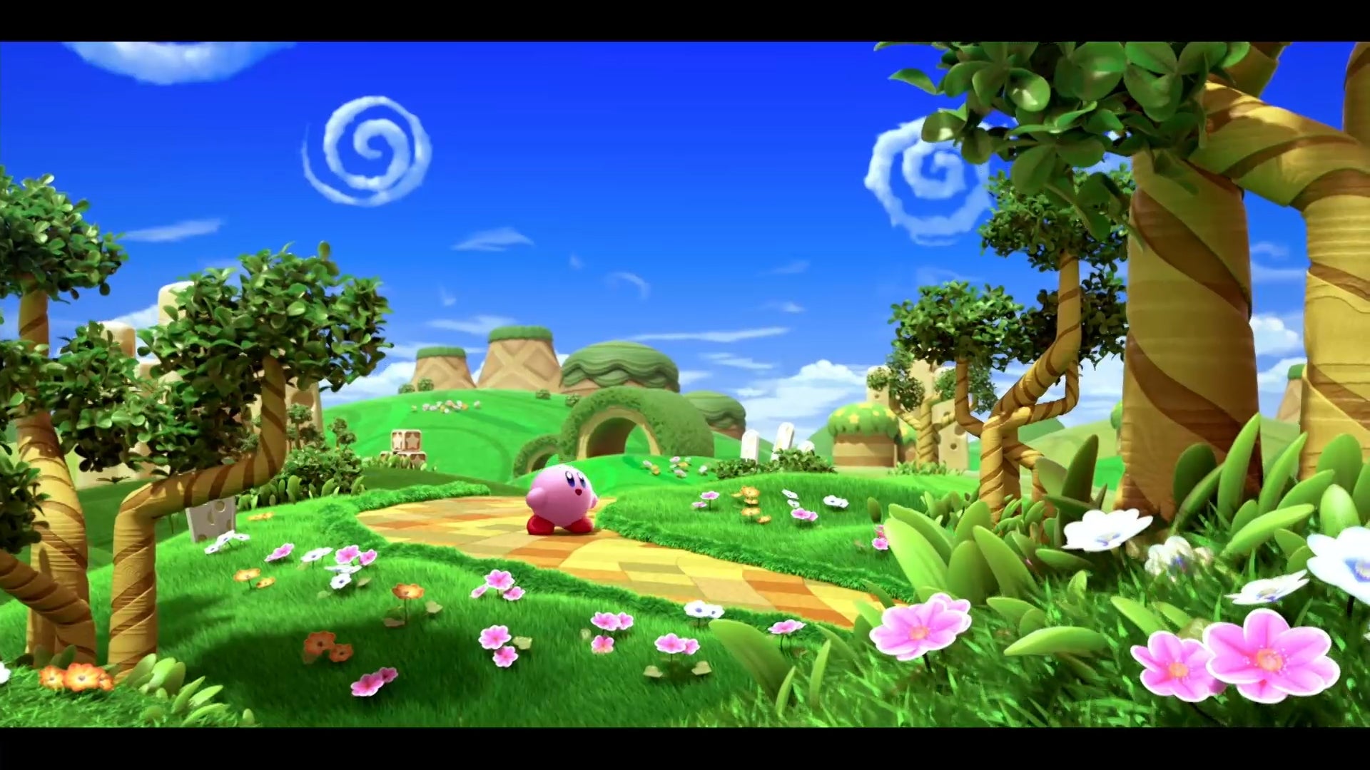 卡比和被遗忘的土地-卡比在一个非常明亮的土地上，绿色的草，粉红色的花和蓝色的天空