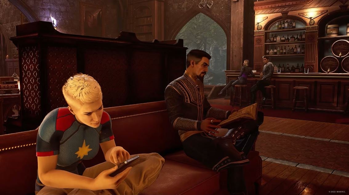 2022 best games Marvel's Midnight Suns - Dr Strange and Captain Marvel read books and phones respectively on the sofa