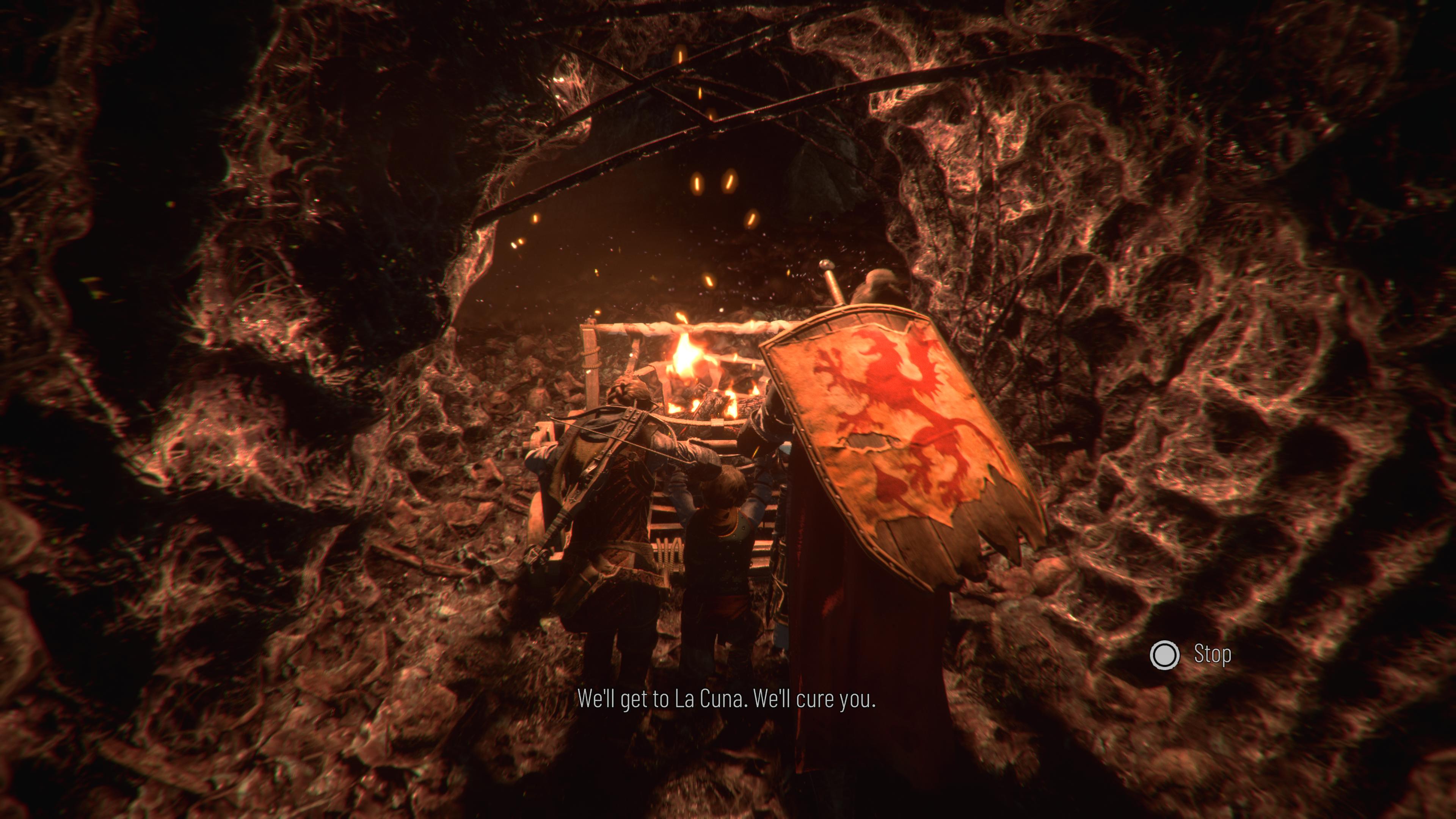 The inside of a rats' nest where three heroes with a burning flame push a cart in the dark.