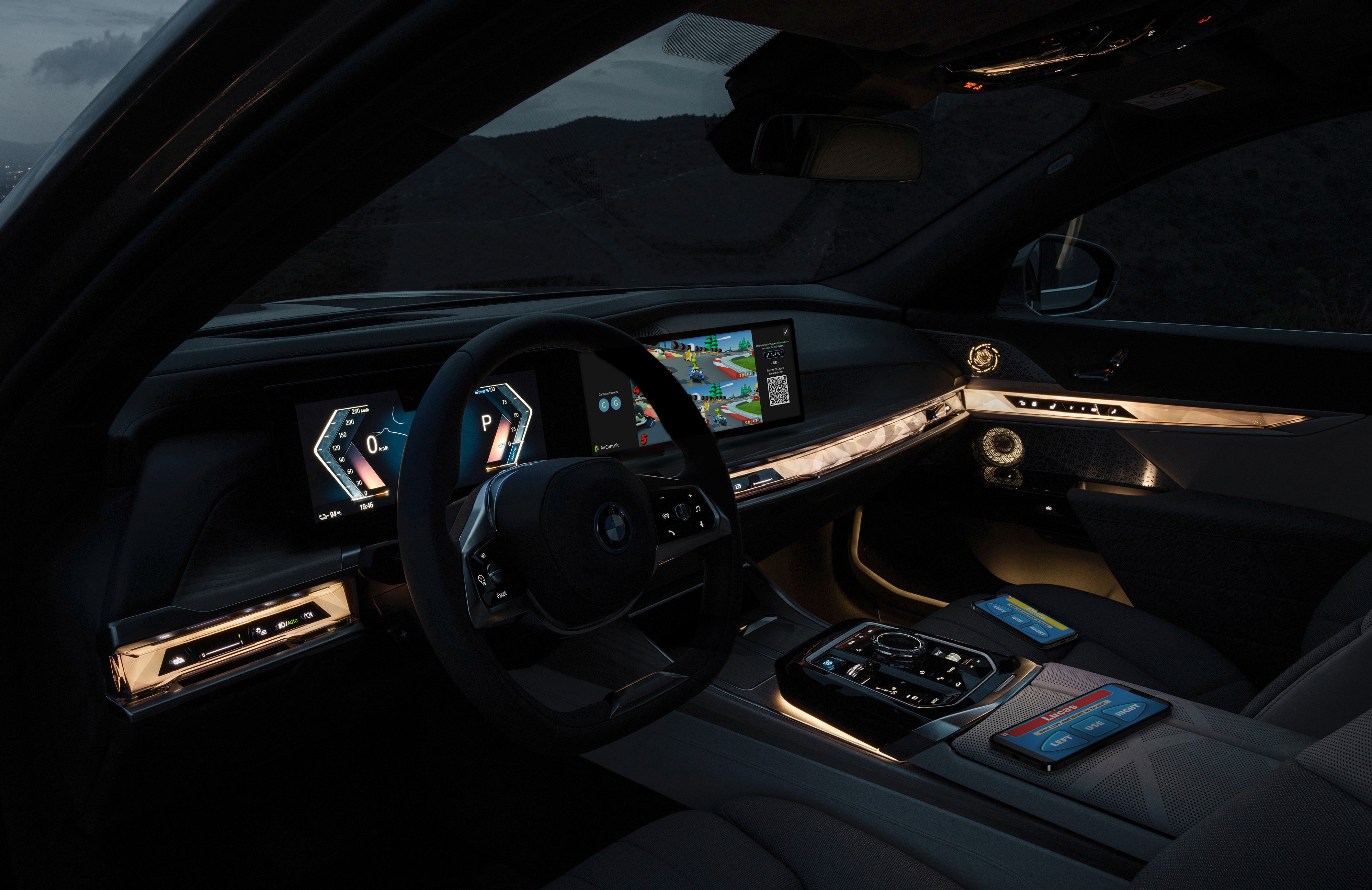 inside shot of a BMW car at night with a game running