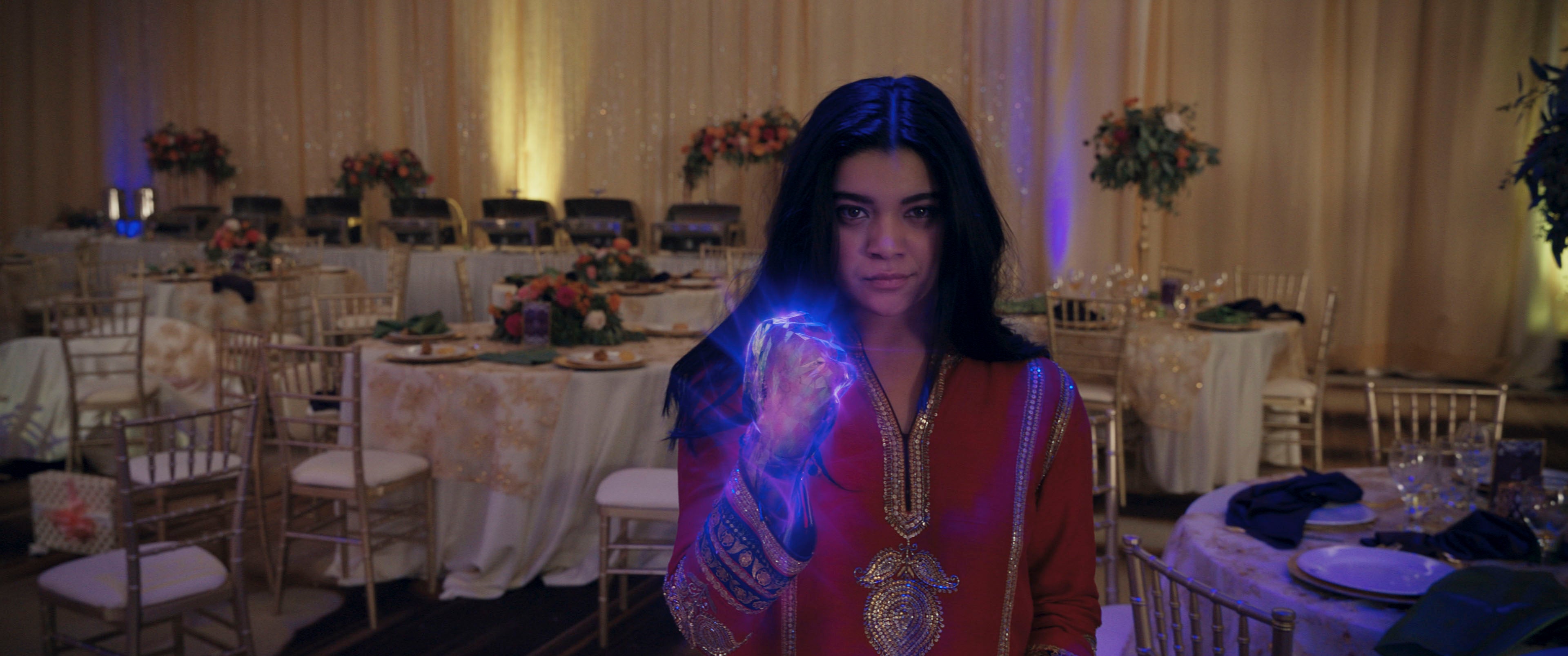 Ms. Marvel still Iman Vellani as Kamala Khan holding up a glowing purple fist