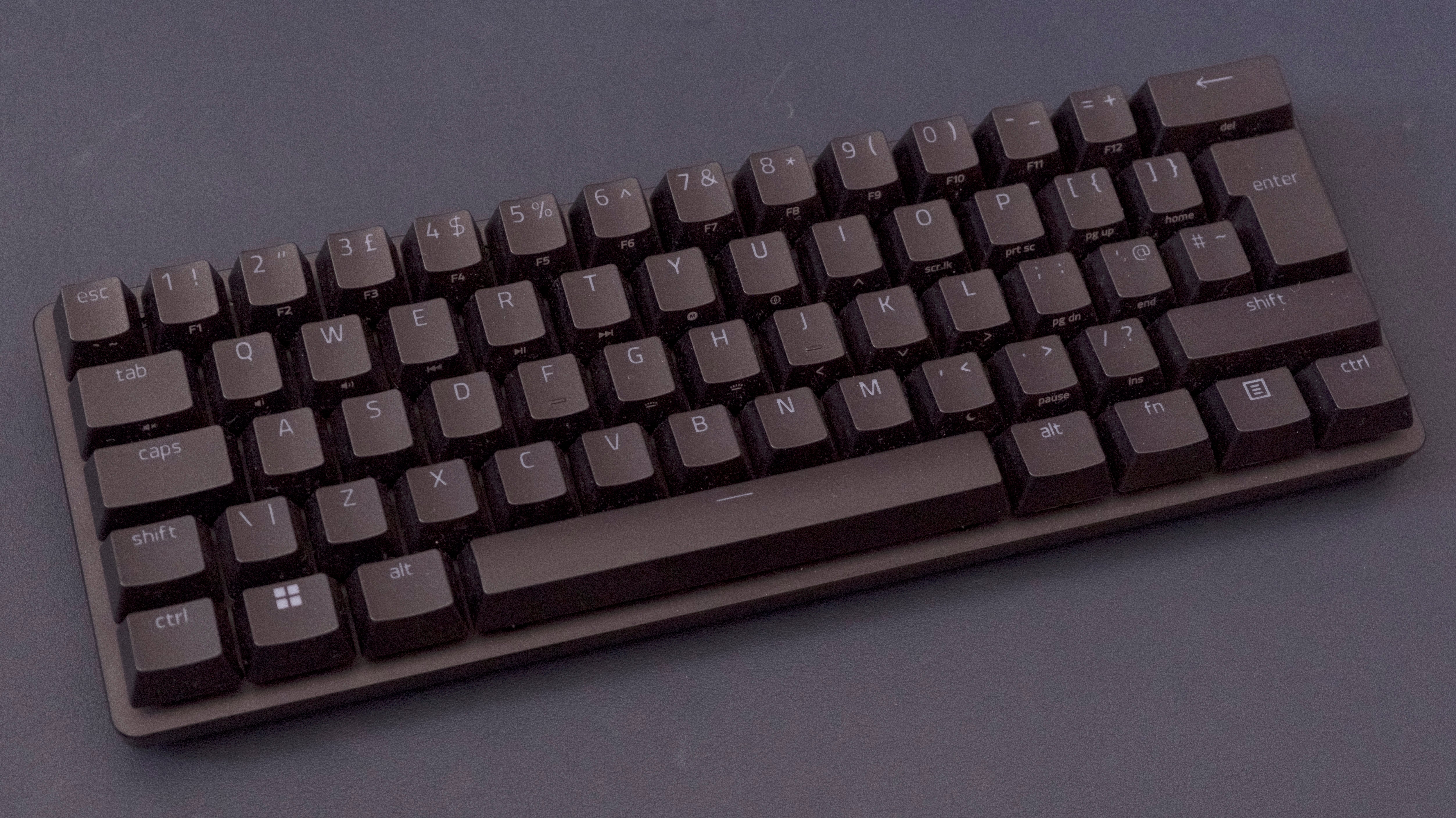 a razer huntsman mini analog keyboard, with a compact and simple black plastic chassis but more interesting analogue switches beneath