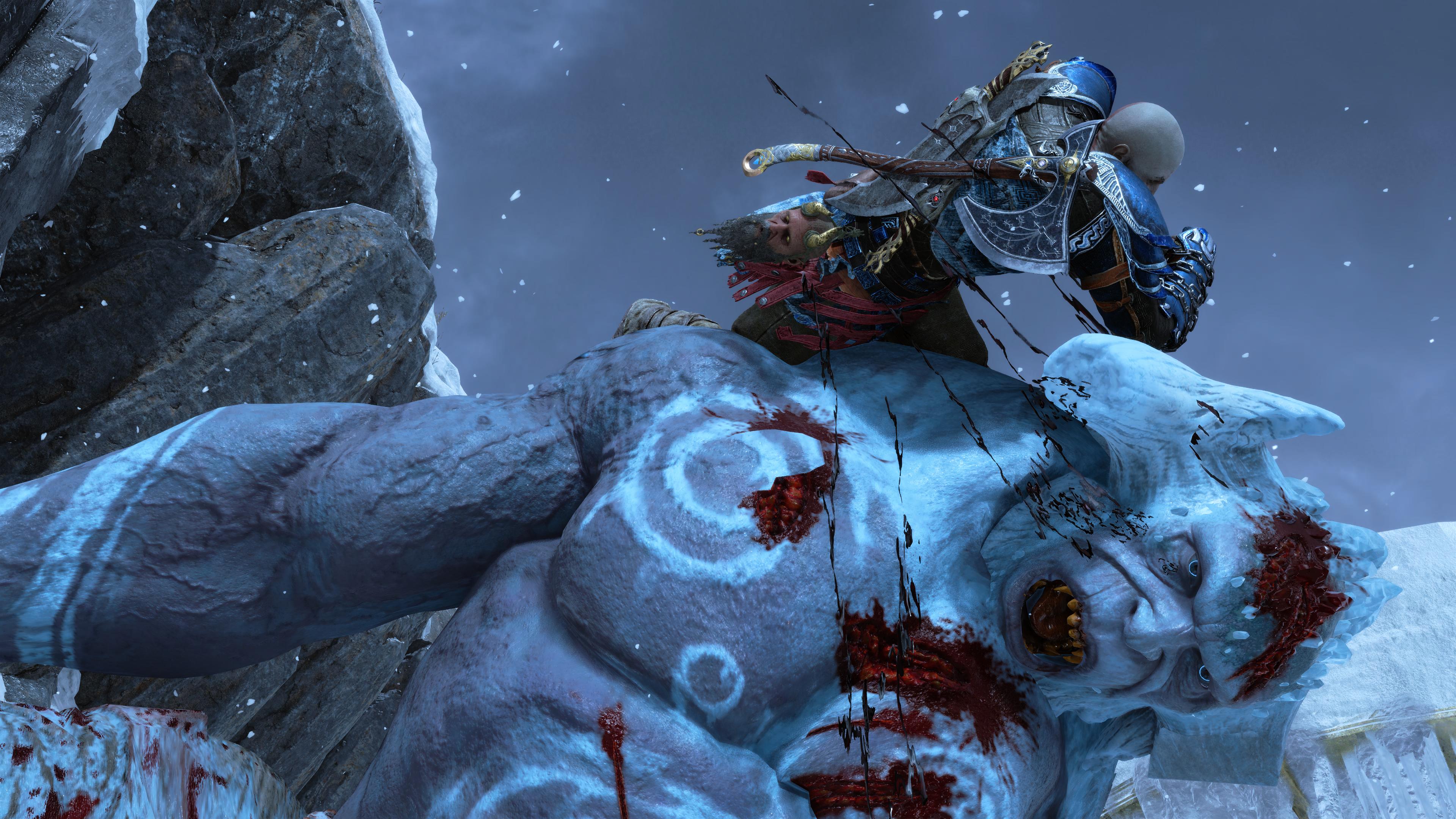 God of War Ragnarok review - Kratos midway through an execution of a big frost troll