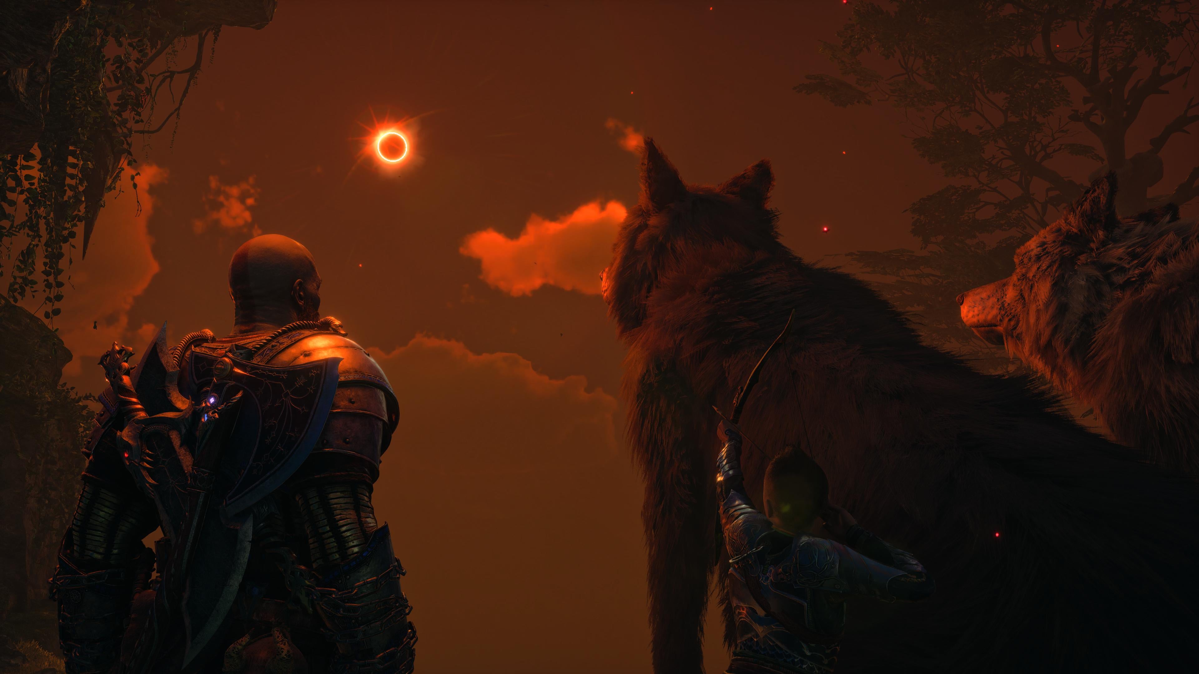 God of War Ragnarok review - Kratos, Atreus and a giant wolf look at an orange-hued eclipse as Atreus nocks an arrow