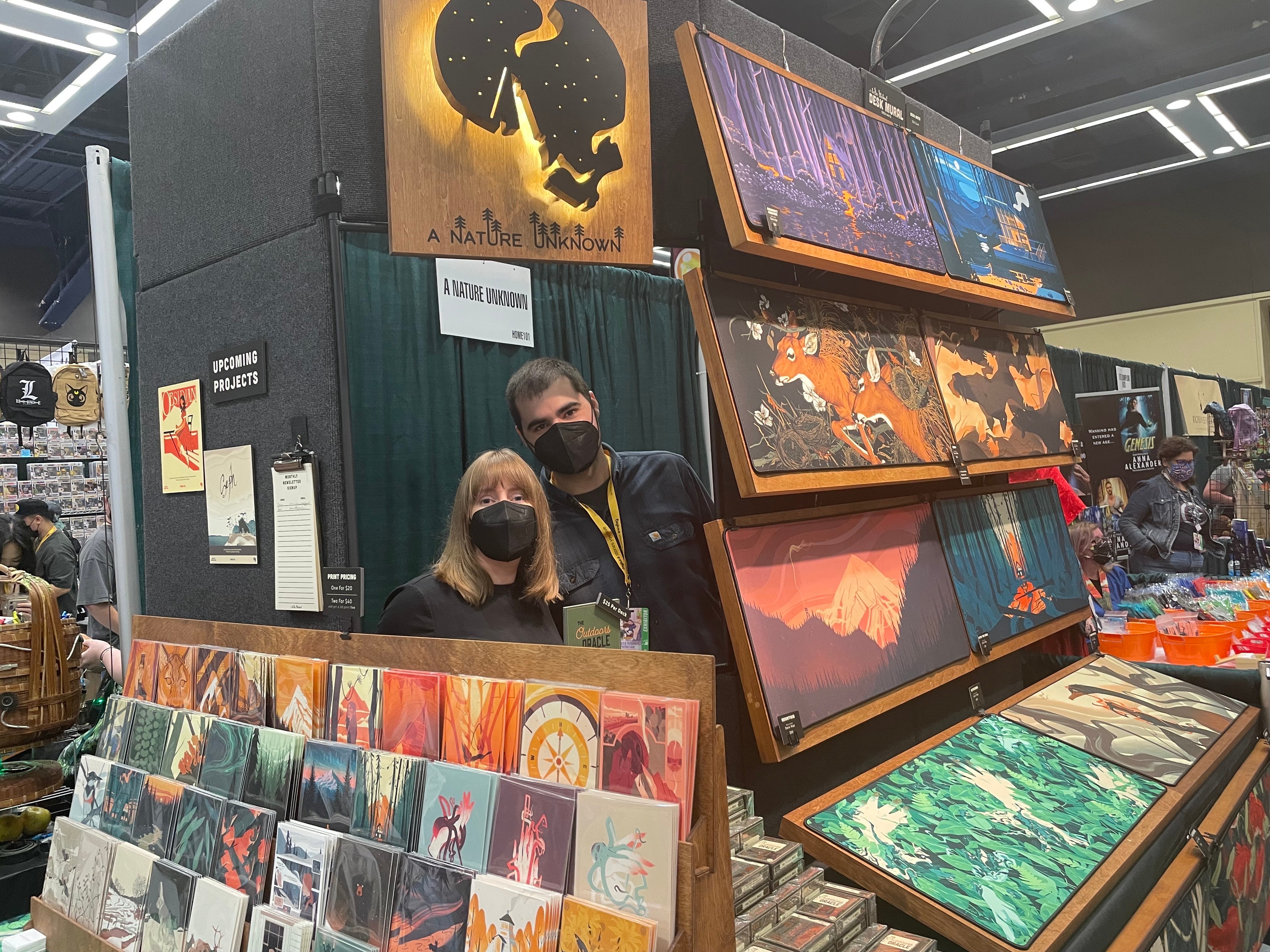 Image of two artists inside of their booth