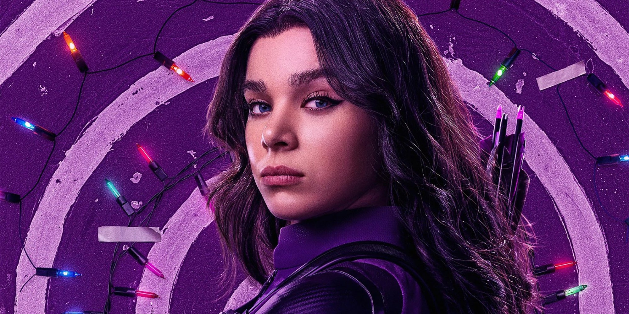 Kate Bishop Character Poster: A promotional poster for the Disney+ show Hawkeye, featuring Hailee Steinfeld as Kate Bishop posing in her purple costume in front of Christmas lights.