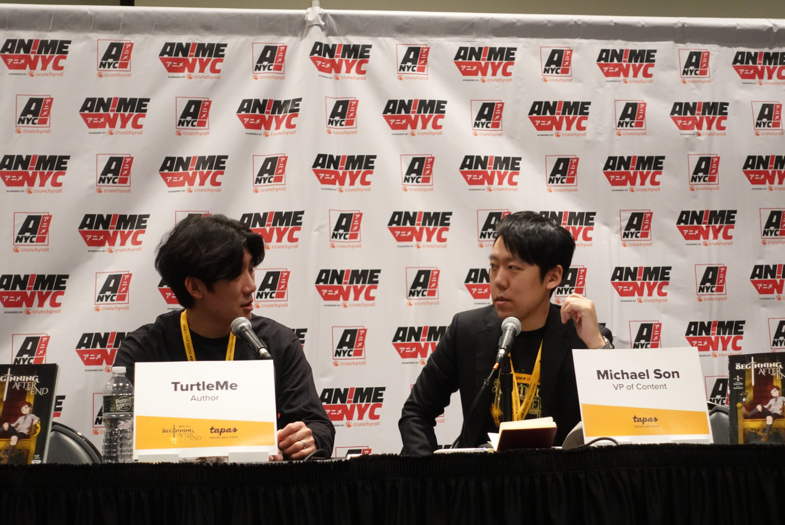 TurtleMe and Michael Son sitting at panel in front of microphones