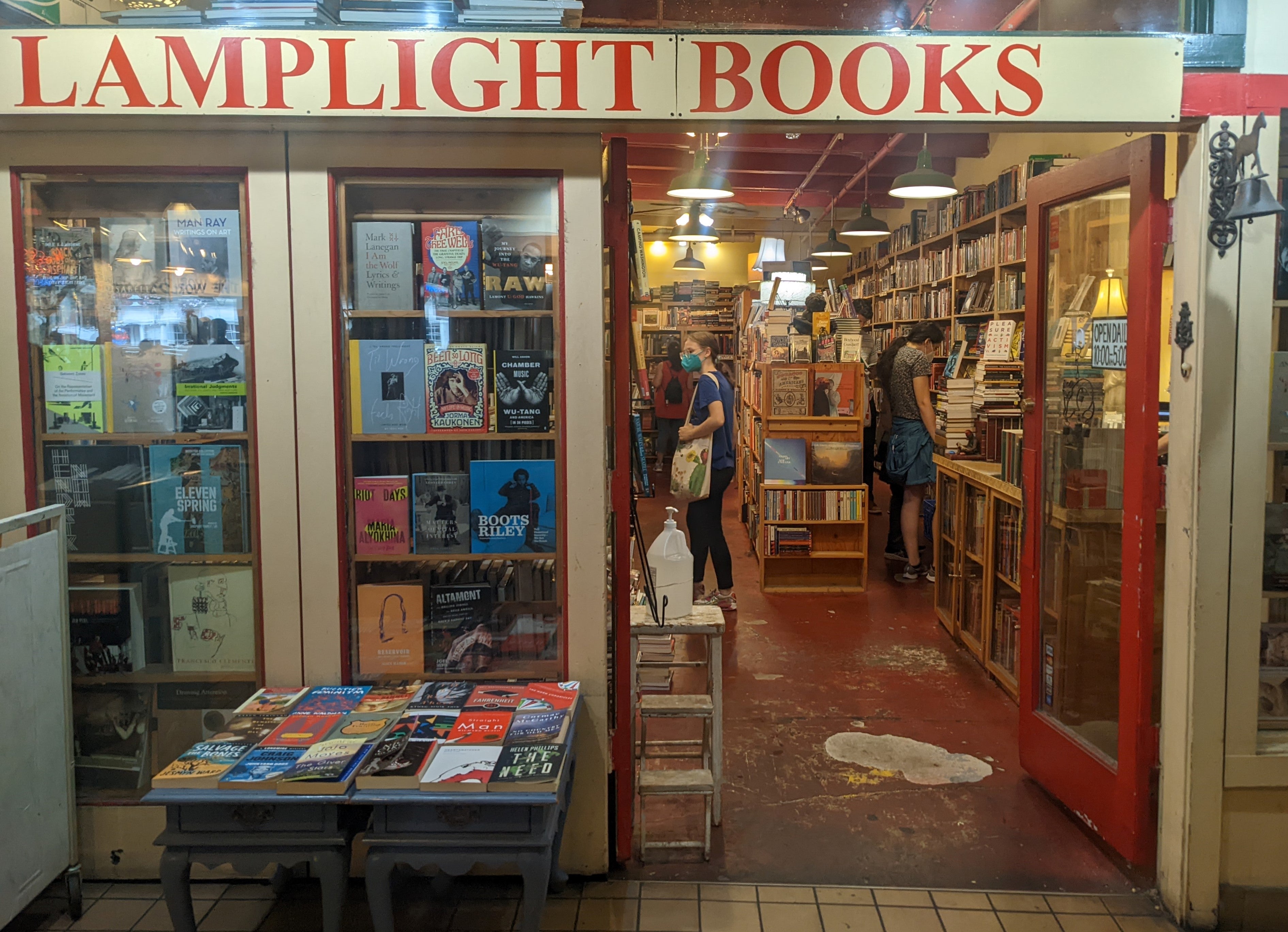 Photograph of a bookstore with a sign that reads Lamplight Books