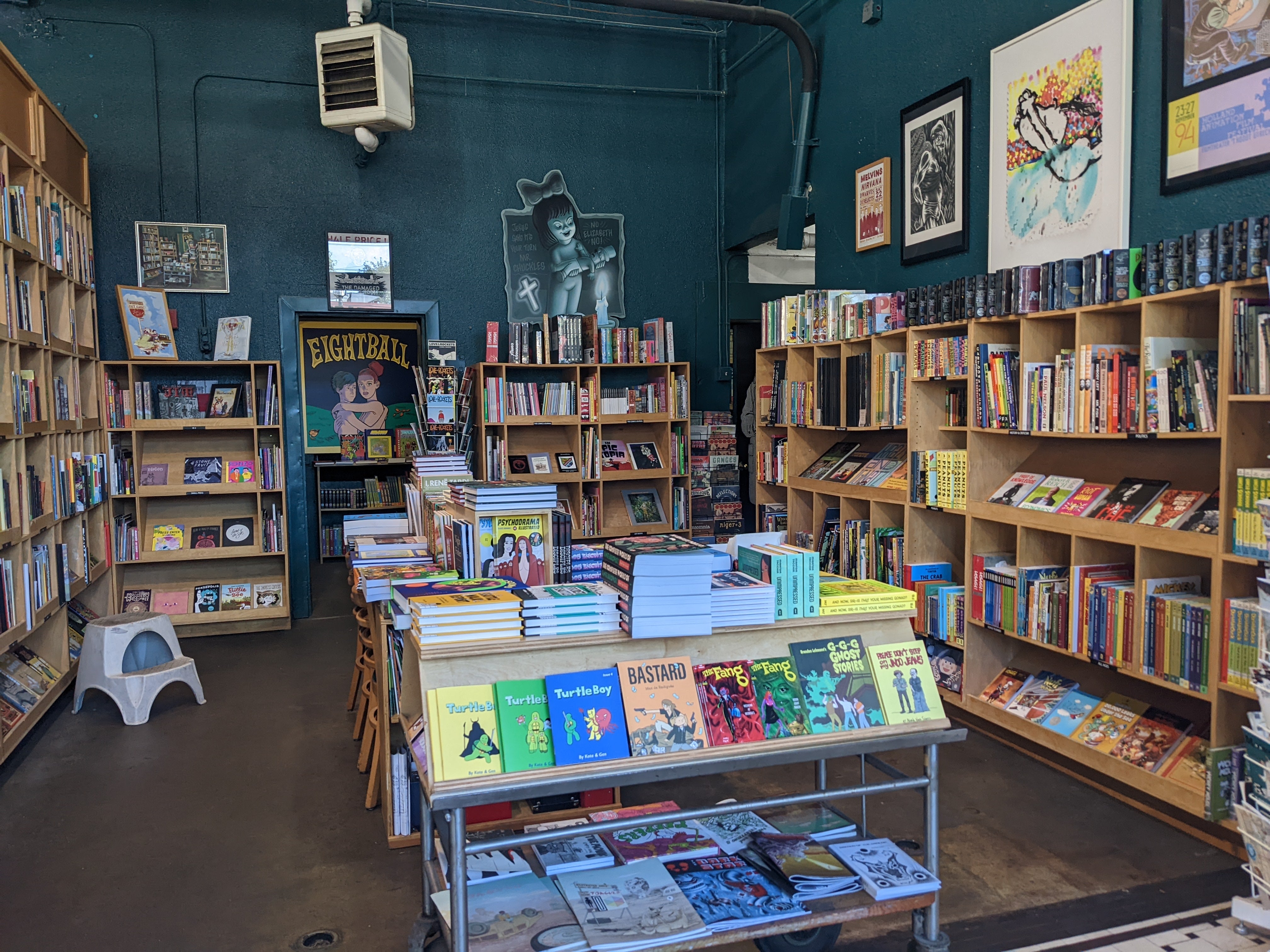 Photograph of the interior of a bookstore with blue walls
