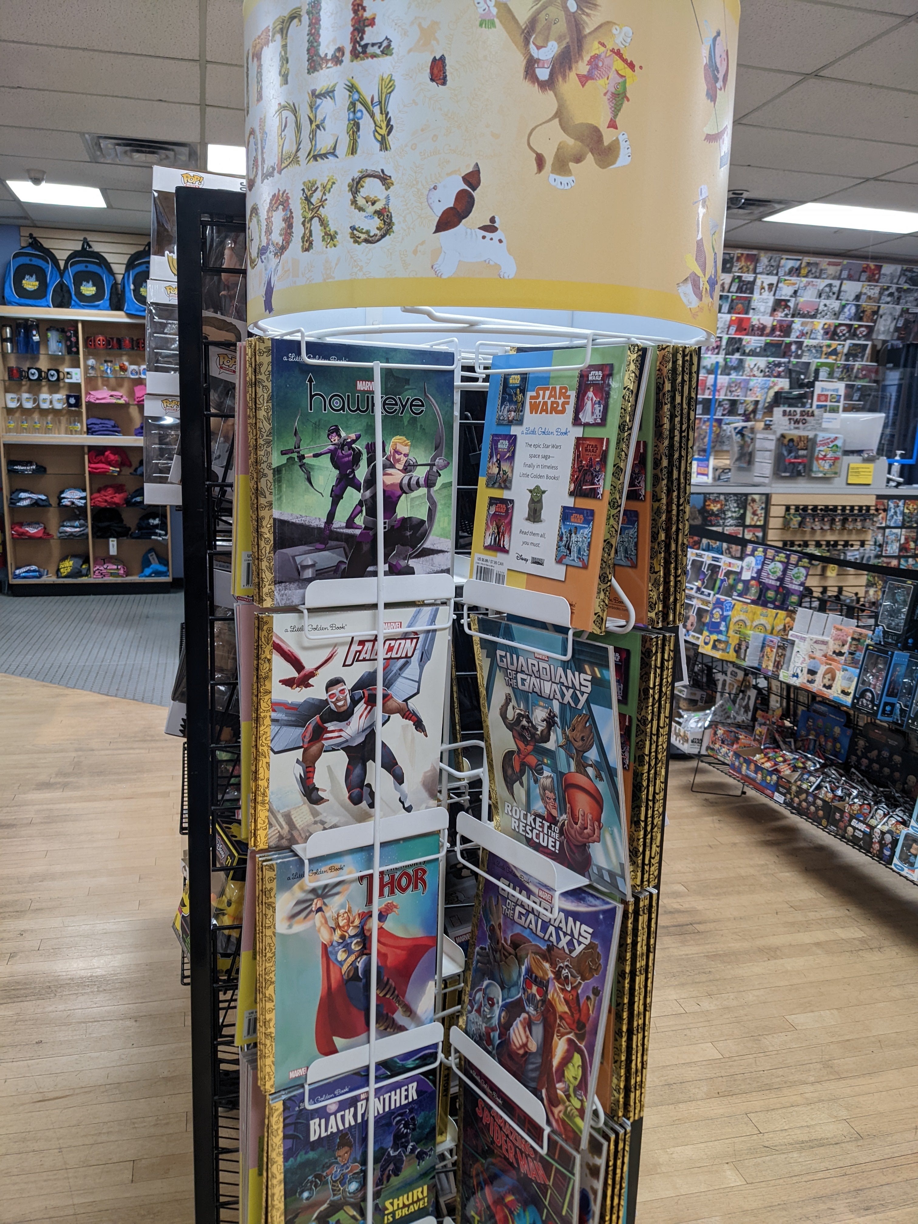 Photograph of a spinner rack featuring Little Golden Books with superheroes on them