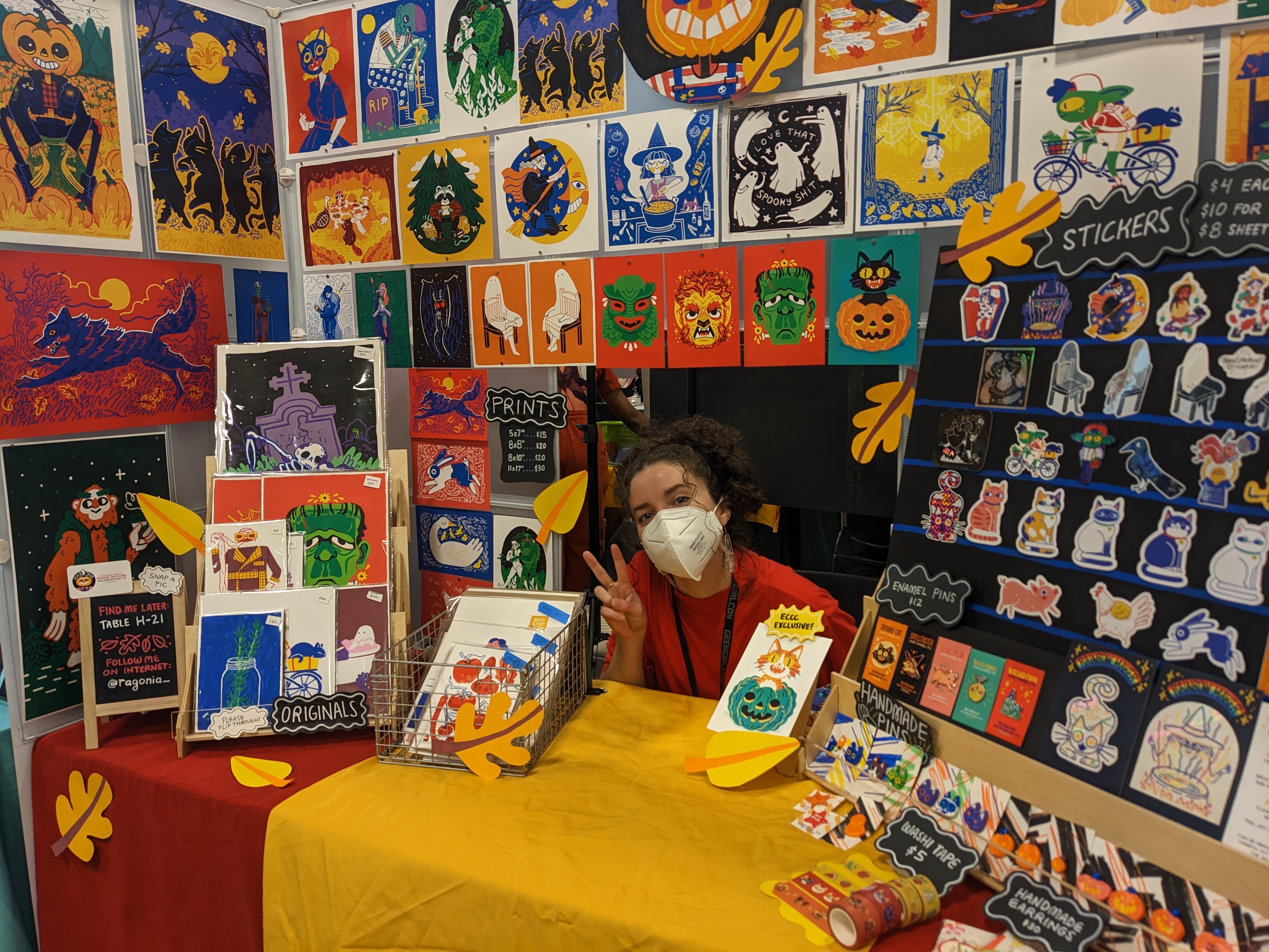 Photograph of artist sitting inside her booth