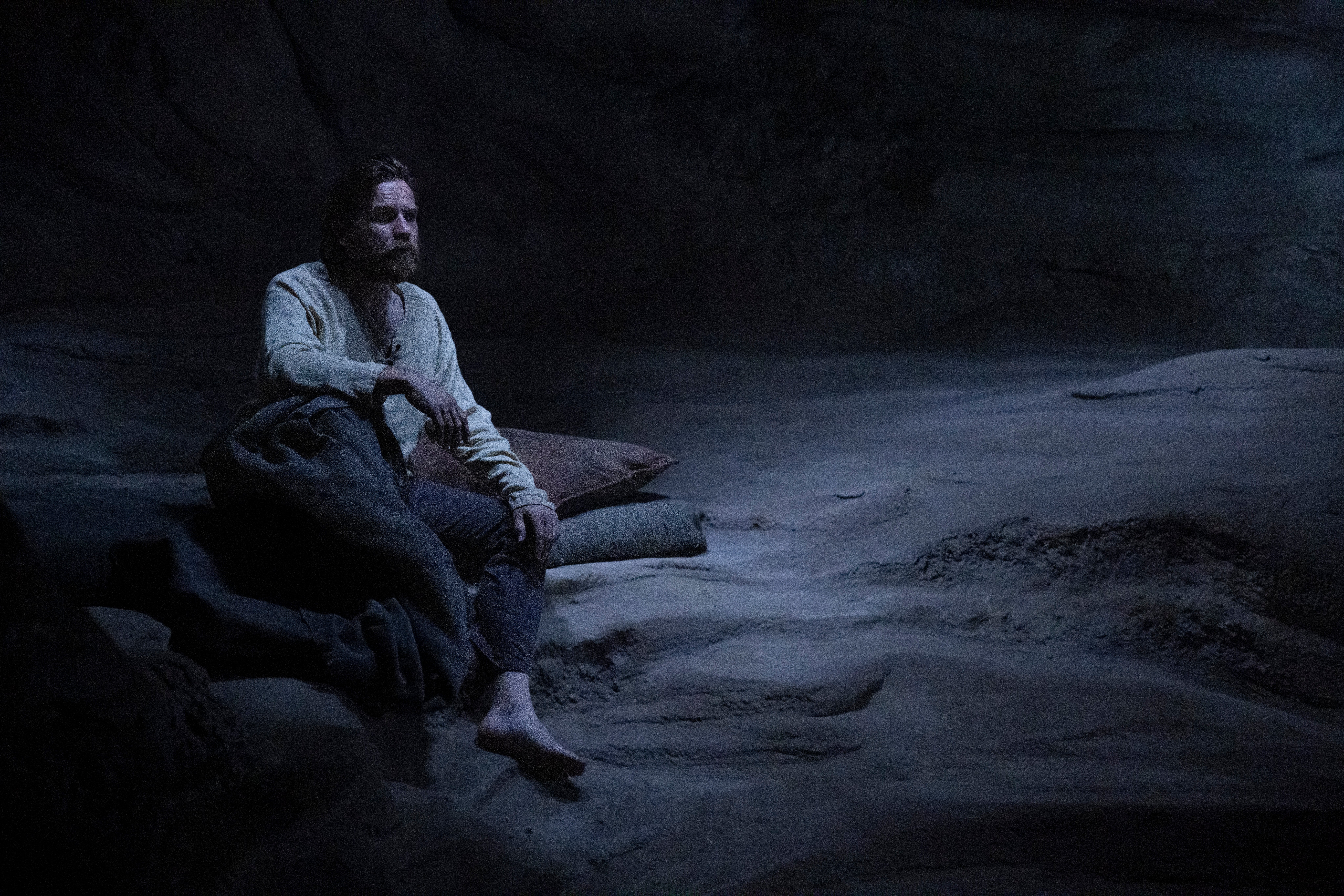 Image of Ewan Mcgregor as Obi Wan Kenobi sitting in a cave