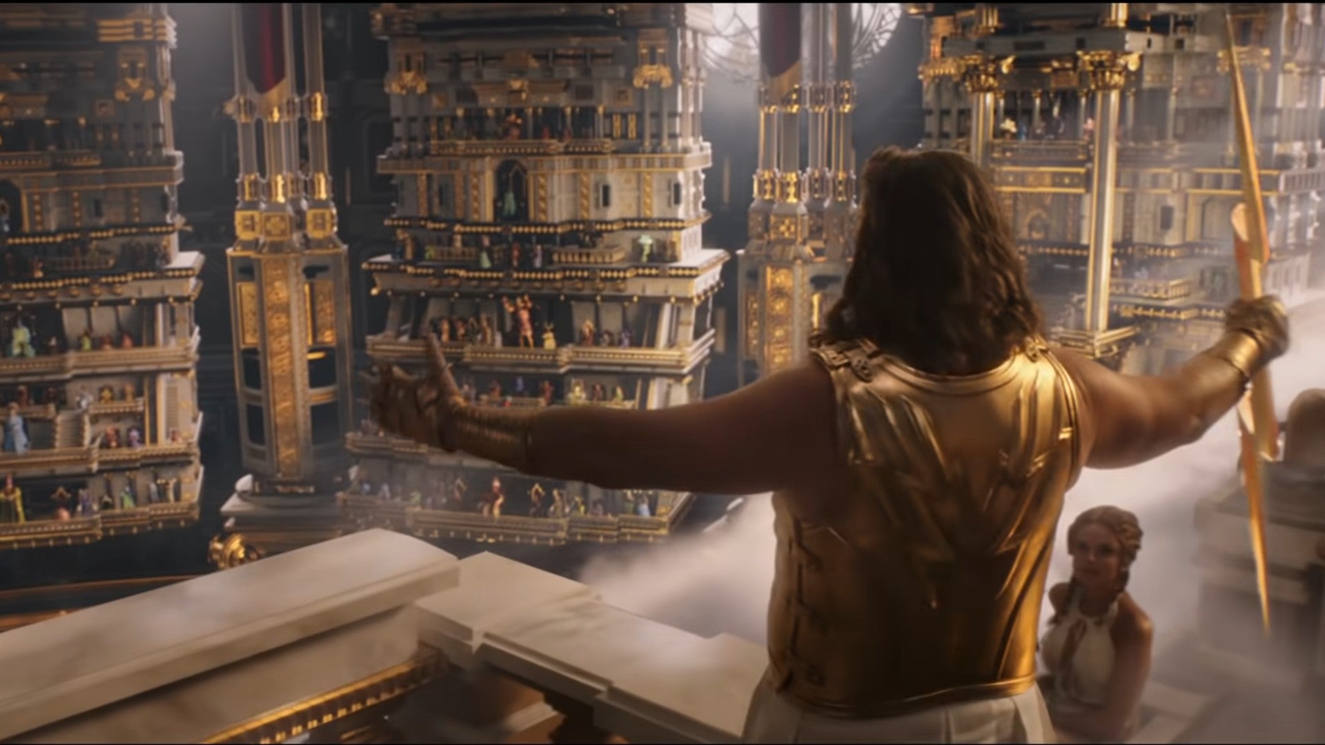 Still from Love and Thunder trailer showing the back of Russell Crowe as Zeus, holding a lightning bolt