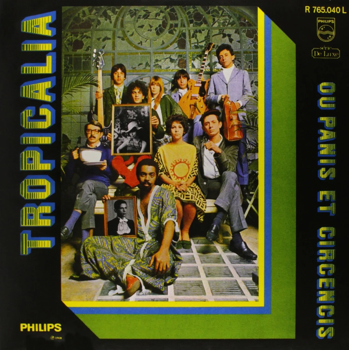 Cover of album, in green and black featuring a photo of people looking directly at the camera