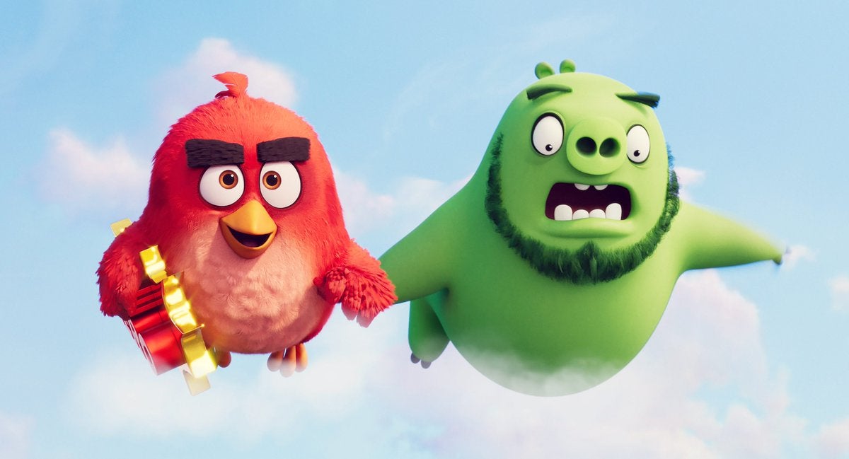 A bird and a pig fly hand-in-hand in The Angry Birds Movie 2
