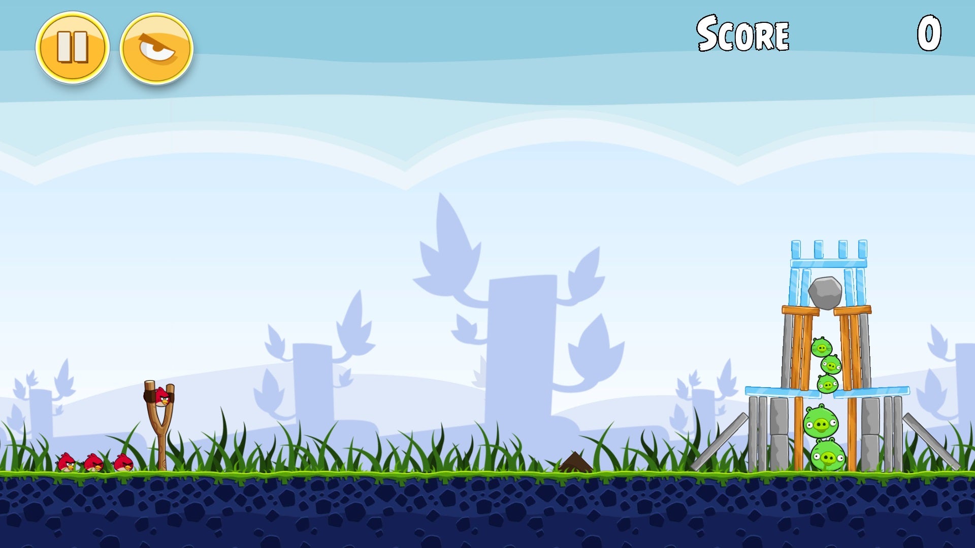An Angry Birds level shows a handful of red birds near a slingshot apparatus aimed at five green pigs in a precariously constructed fort of ice, stone, and wood blocks