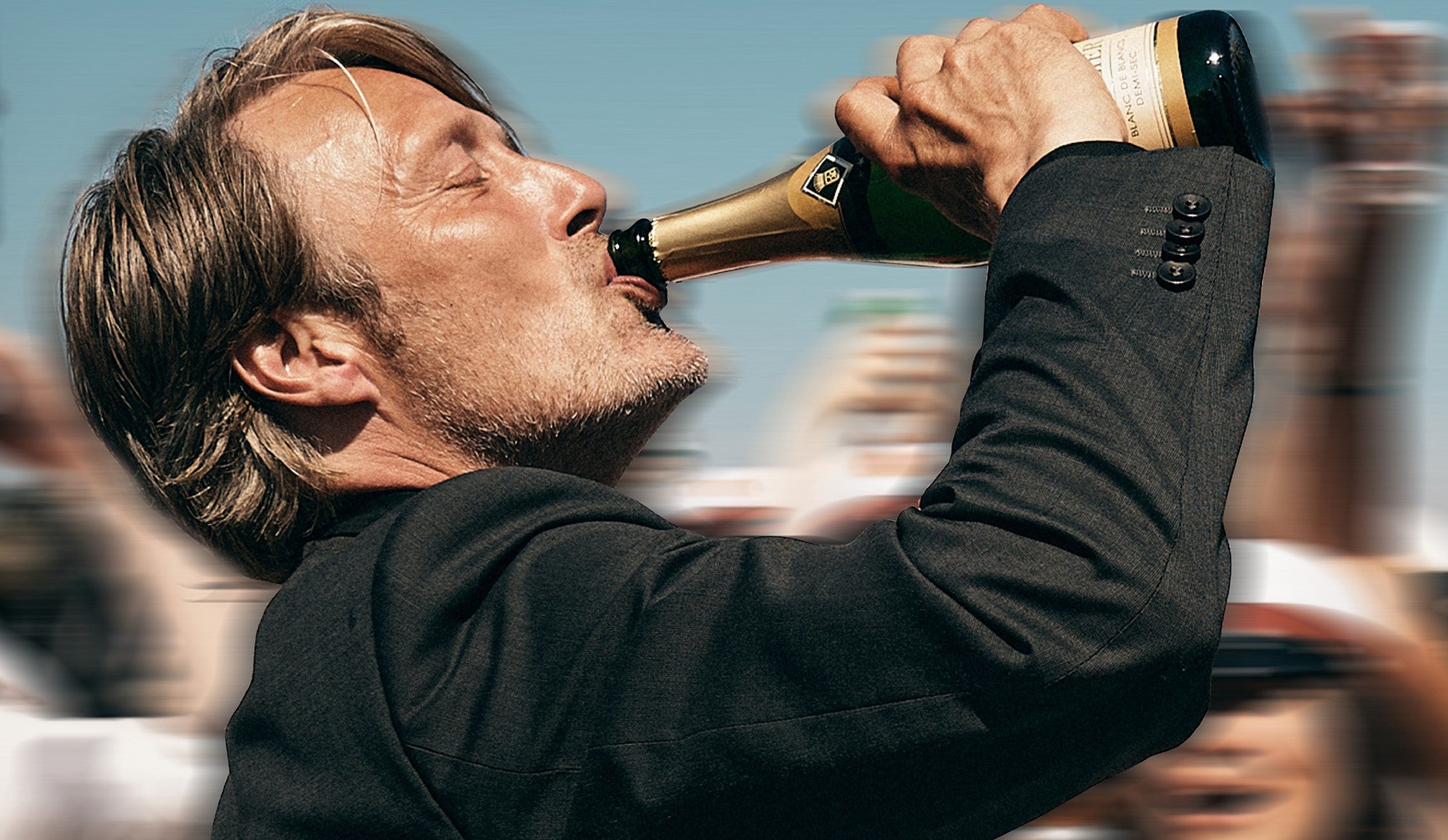 A cropped poster of Mads Mikkelsen drinking from a champagne bottle