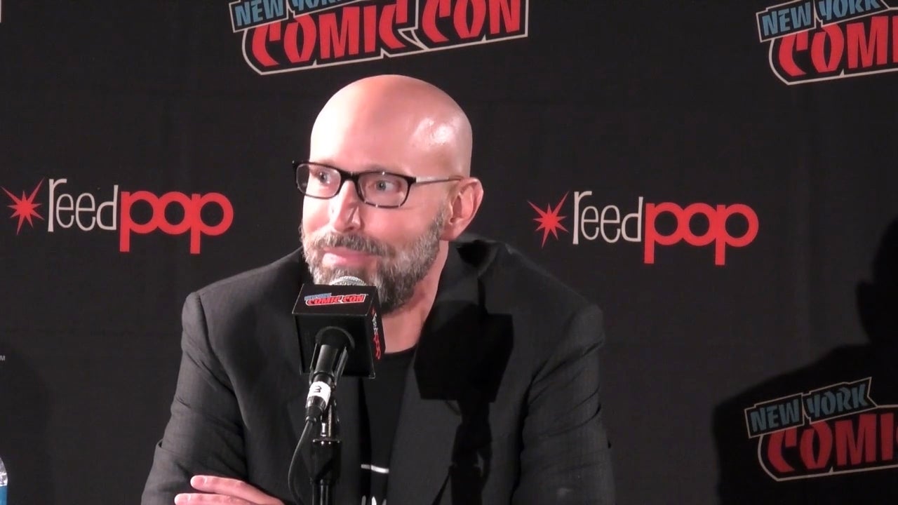 Brian K Vaughn wearing glasses in front of a Reedpop New York Comic Con background