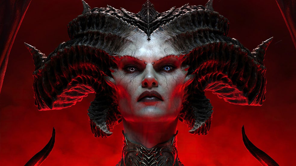 Diablo 4 antagonist Lilith, close up, looking imperiously down at the camera, huge horns spiralling back and away from her head. The background is hell-red. She's not messing around.