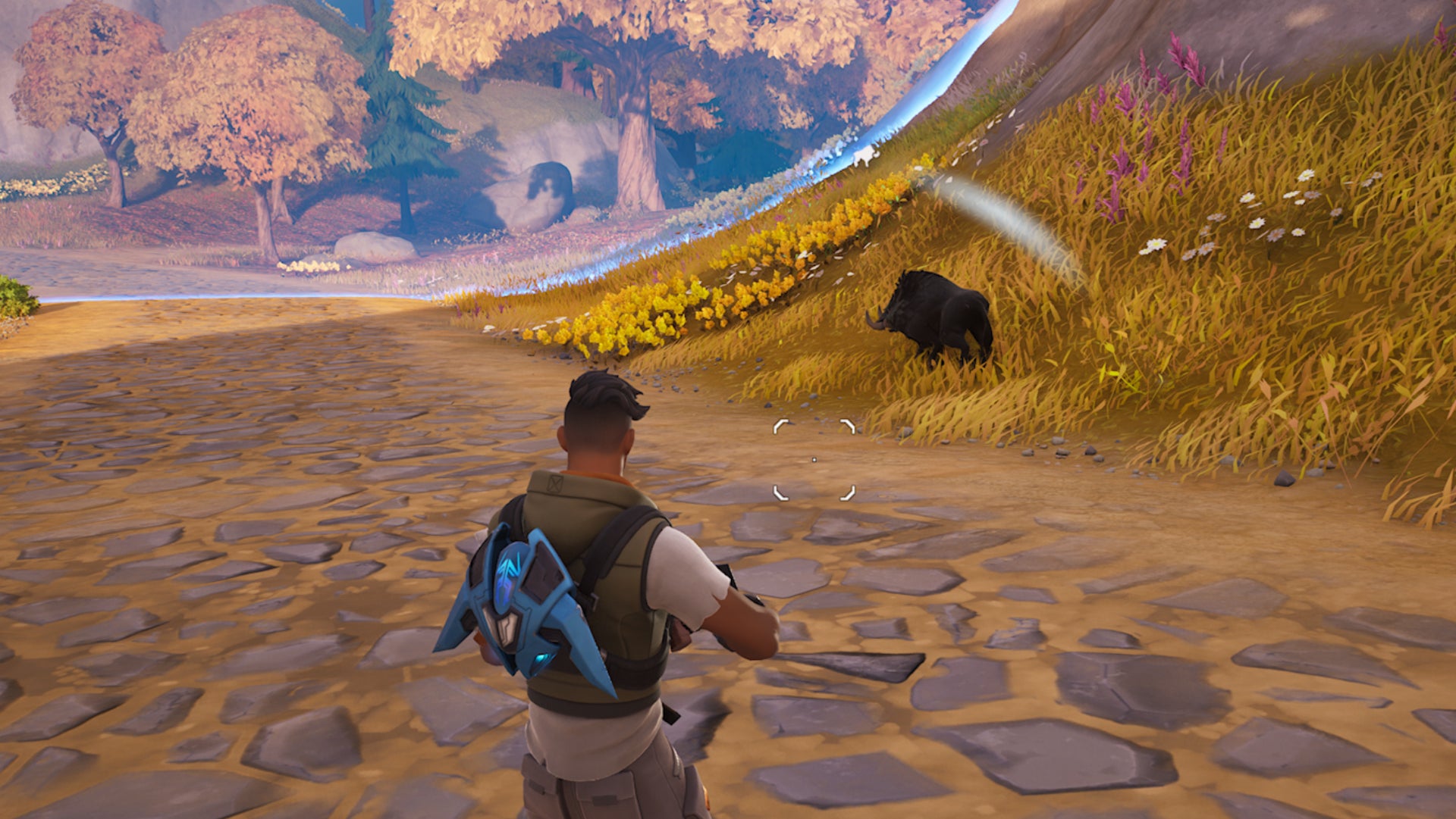 Fornite, a character is facing a Boar that is standing near the edge of the storm.