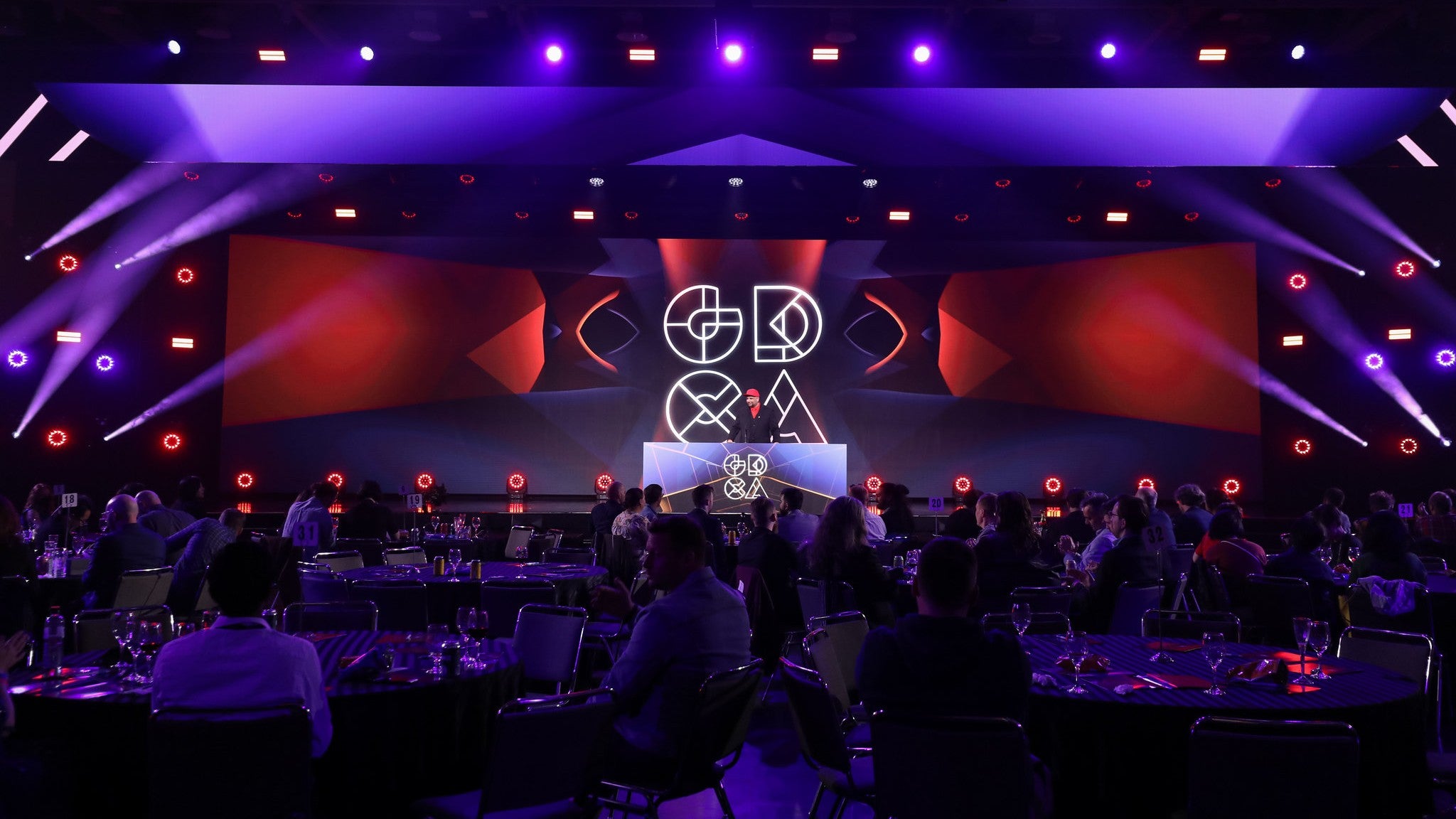 The stage of the 2022 Game Developers Choice Awards with the GDCA logo on the backdrop