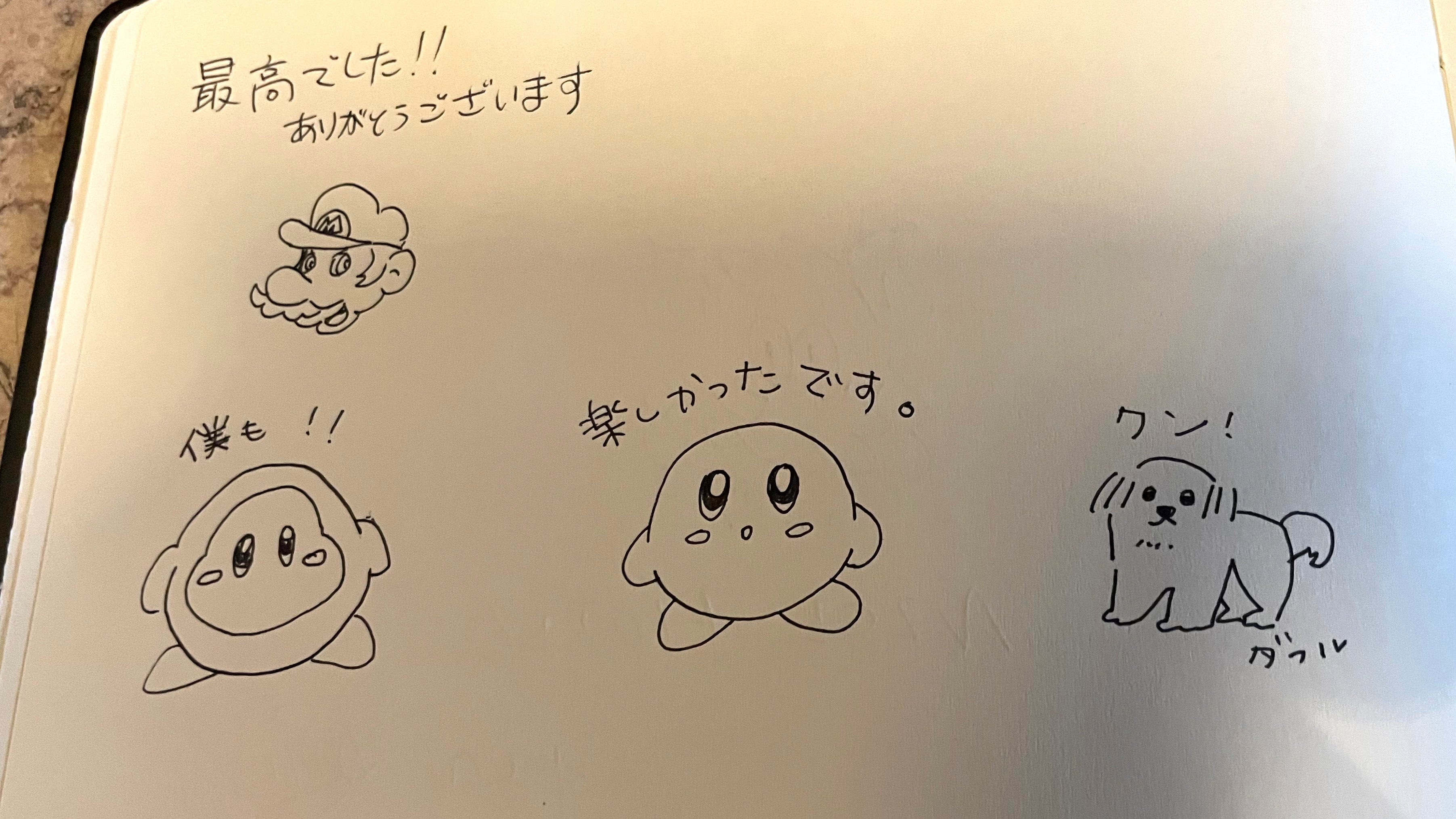 A hotel guestbook but one with the Nintendo characters Mario and Kirby, and Japanese writing annotating them.
