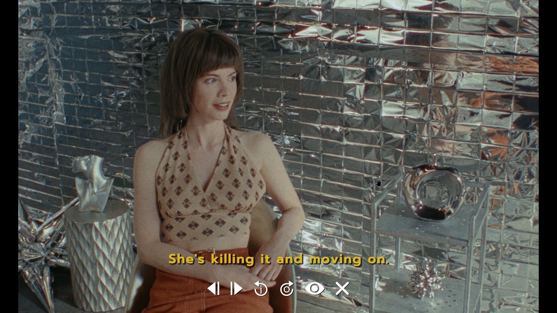 Immortality review - Marissa interviewed in front of a shiny reflective wall during a making-of documentary in 1970