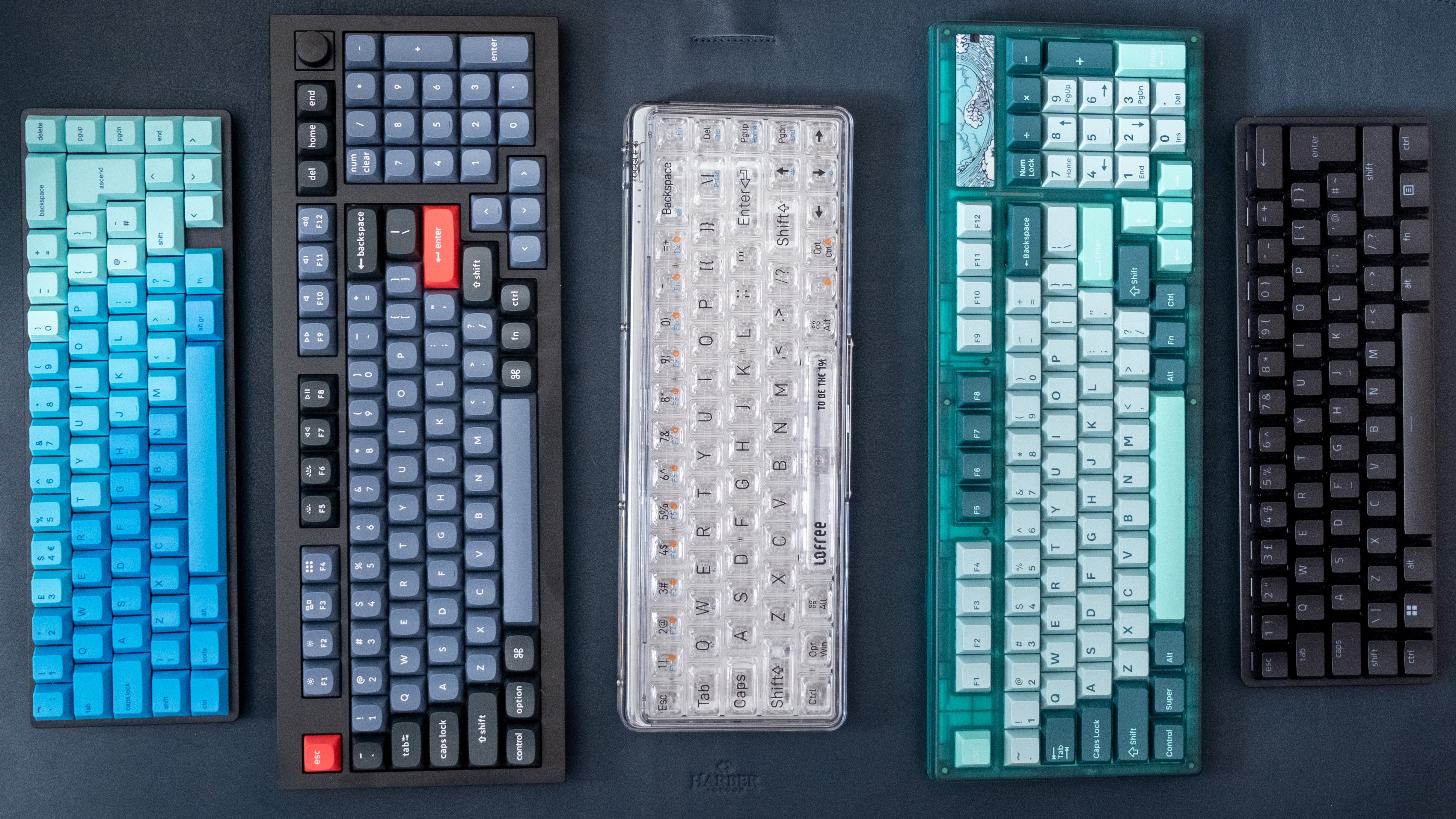 keyboards arranged in a line, featuring interesting colour schemes, form factors and features