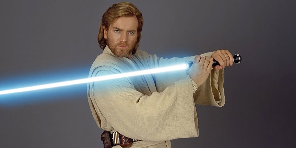Ewan McGregor as Obi-Wan Kenobi wielding a blue lightsaber.
