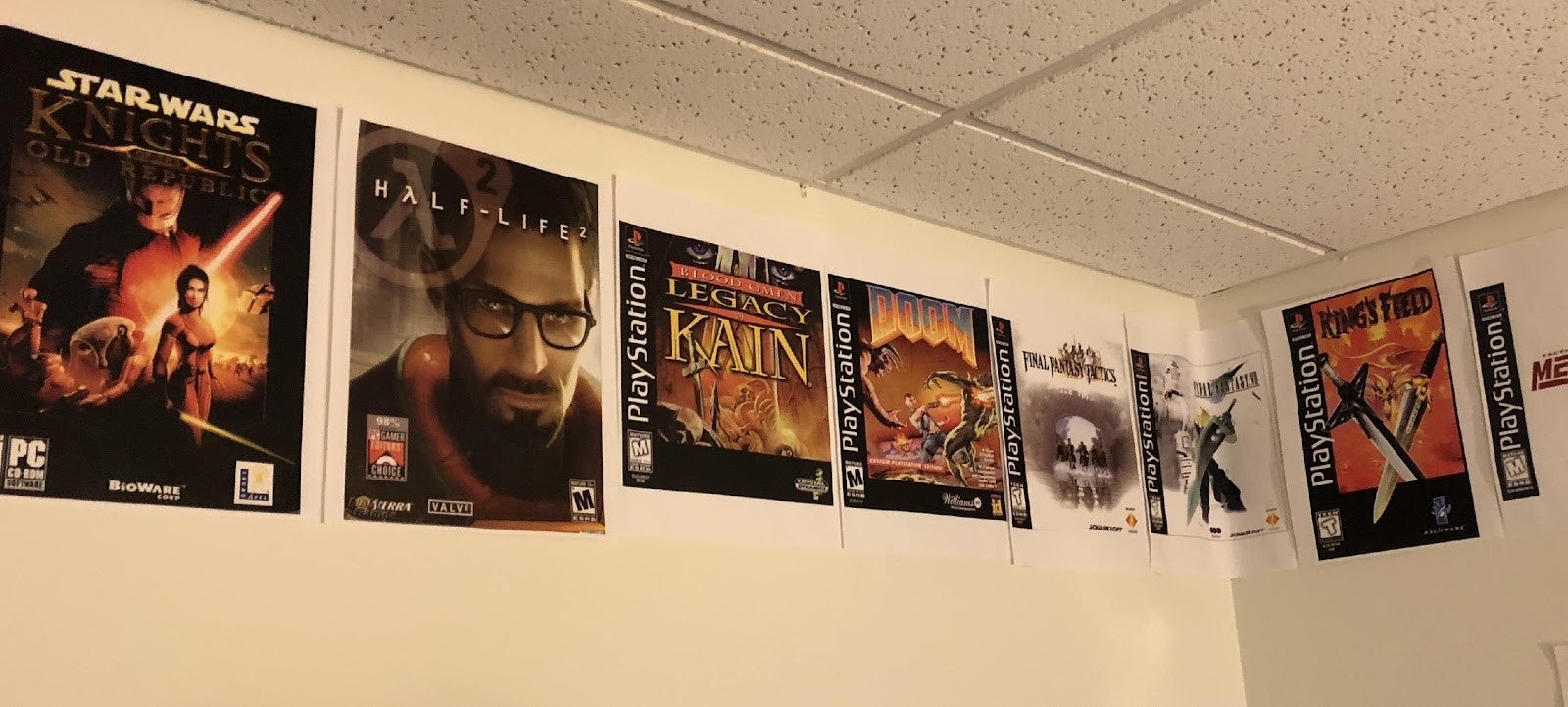 An office wall with posters for Half-Life, Doom, King's Field, and others