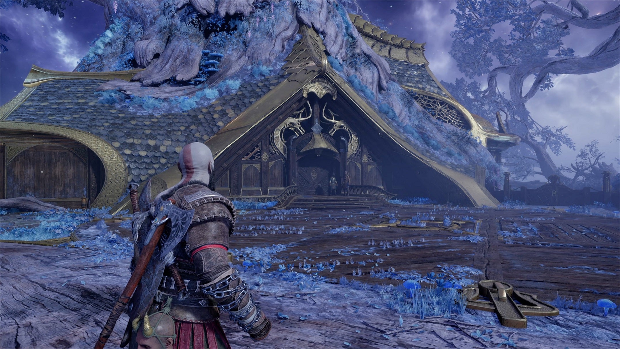 Kratos looks at an strange house in the forest in the PS4 version of God of War Ragnarok