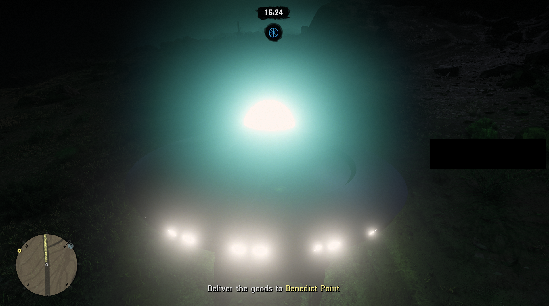Red Dead Online - at night, a UFO fills up the screen, it's a large turquoise light with several smaller white lights along the base, the rest is hard to see