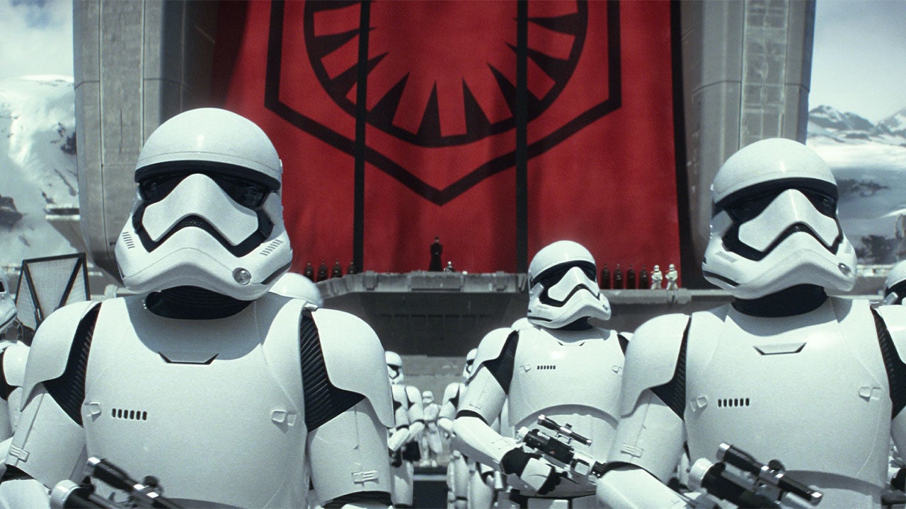First Order Stormtroopers in front of a First Order Flag