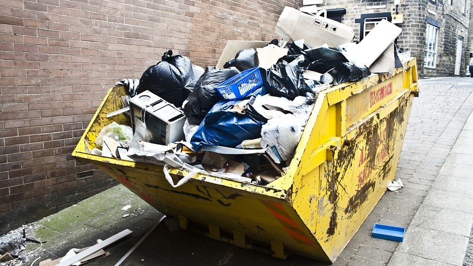 A dumpster overfilled with trash