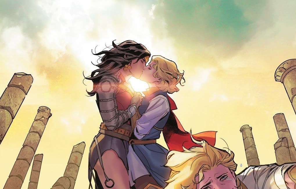 One panel from Dark Knights of Steel #2 by Tom Taylor, Yasmine Putri, Arif Prianto, and Wes Abbott. Wonder Woman kisses a blonde woman, Zara Jor-El, while surrounded by what look like ruined Greek columns.